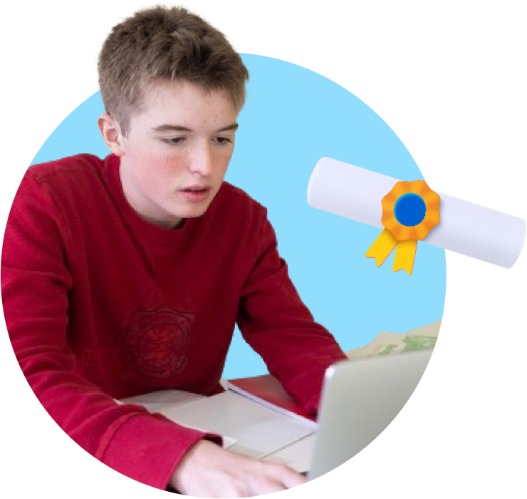 a boy sitting at a desk with a laptop