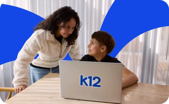 A woman and young boy smile at each other while using a laptop with a "k12" logo. Bright blue abstract shapes add a modern touch. Lighthearted mood.