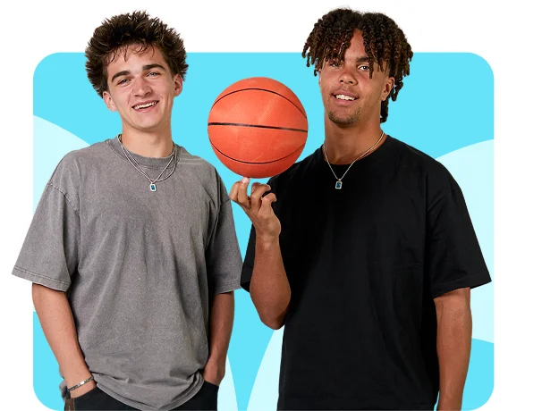 Two young men smiling, one holding a basketball, both wearing casual t-shirts against a colorful background.
