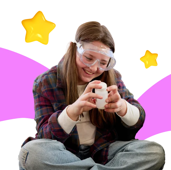 Smiling girl in goggles, wearing a plaid shirt, holds a container. She sits cross-legged against a black background with yellow stars and pink swirls.
