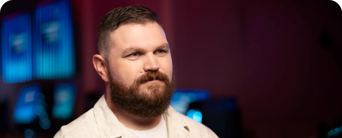 Esports coach or program representative pictured in a competitive gaming environment, highlighting organized student esports opportunities.