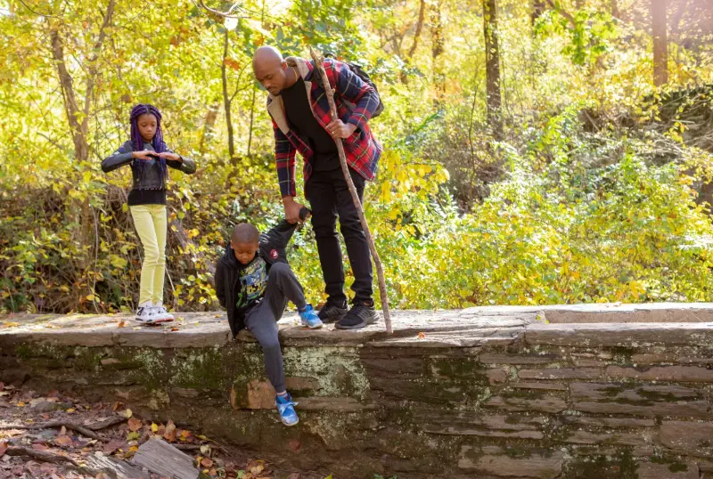 Family participating in an outdoor adventure together, encouraging physical activity, exploration, and confidence-building in nature.
