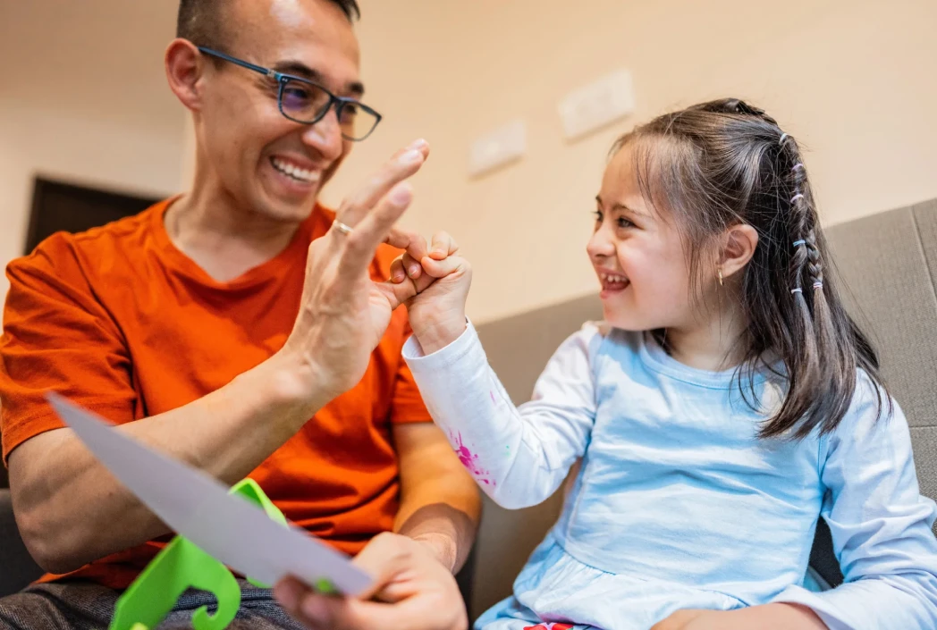Adult supporting a child during an adaptive learning activity, highlighting personalized instruction and inclusive educational strategies.