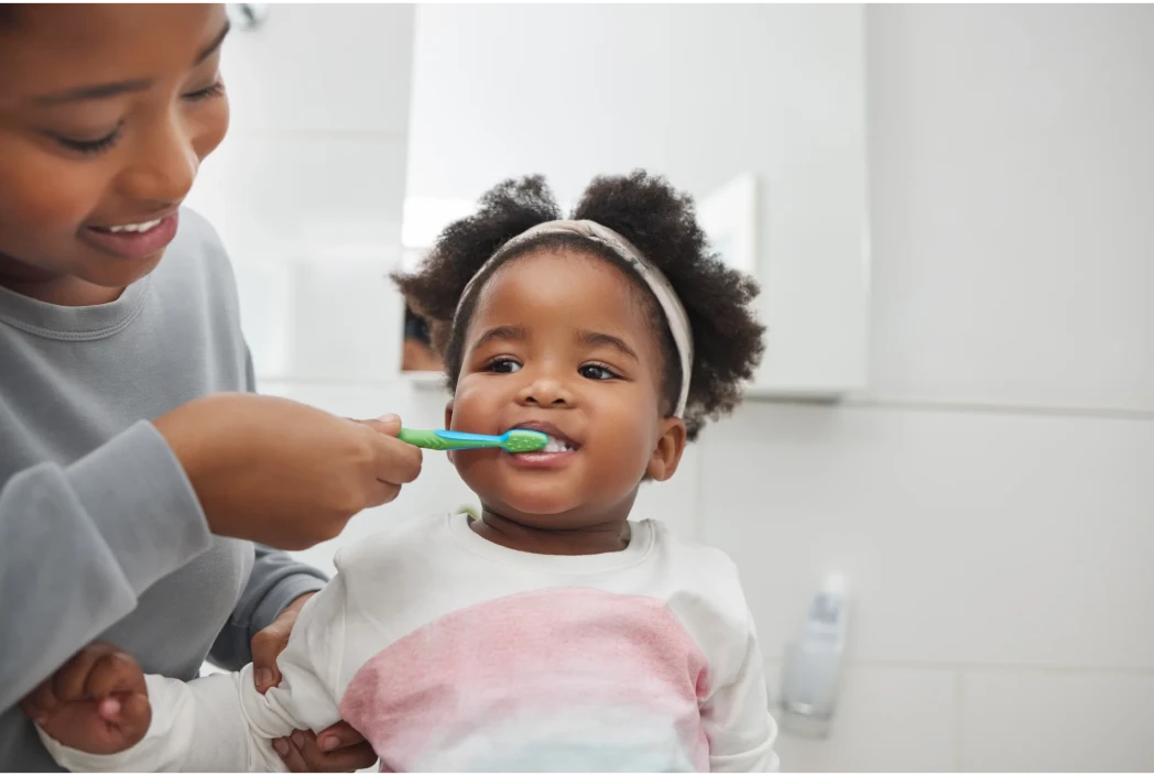 Young child following a morning hygiene routine with support, highlighting healthy habits and preparation for a successful school day.