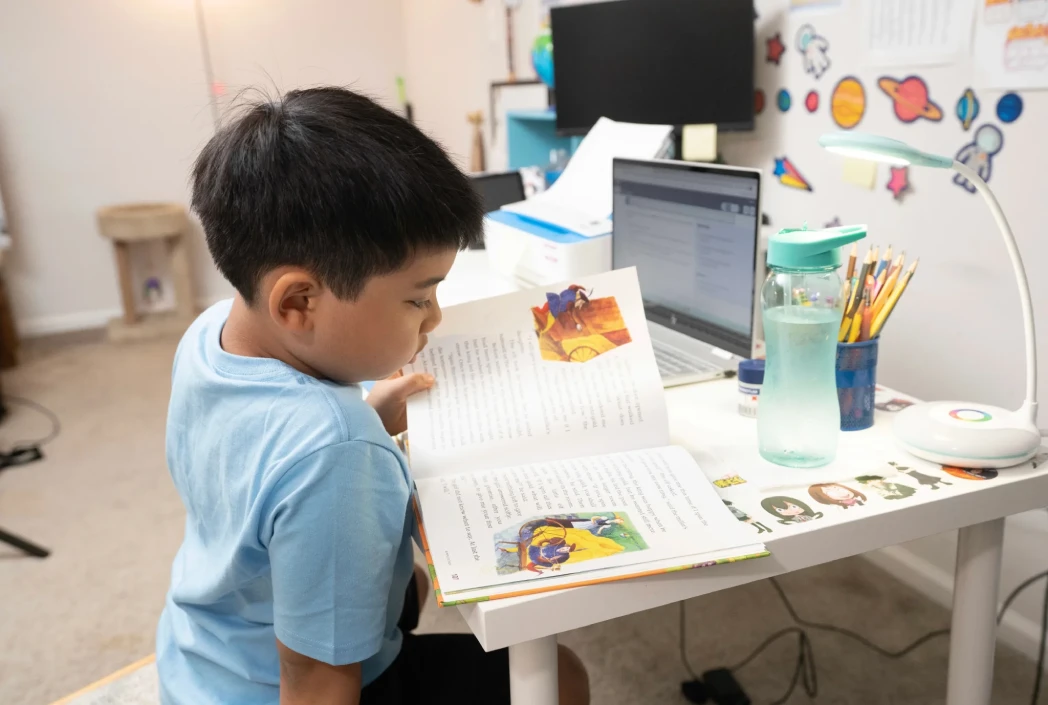 Learner reading independently in a dedicated study space, strengthening literacy skills and confidence before the start of the school year.