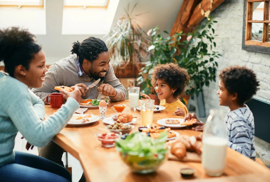 Family enjoying a meal together at home, highlighting quality time, connection, and healthy family routines.