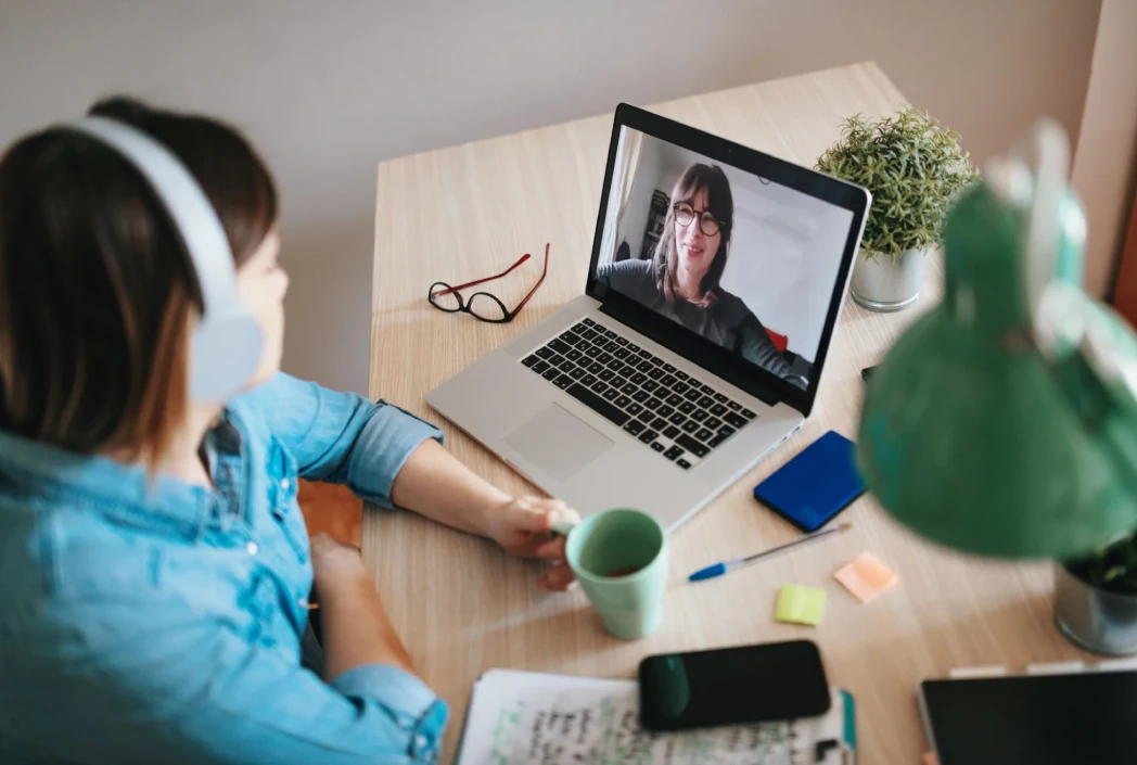 Student participates in a virtual meeting with an instructor, highlighting the personalized support, guidance, and connection available through online learning.