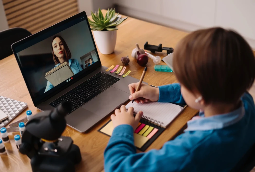 Student attending a live online class and receiving personalized support from a teacher during a virtual lesson.