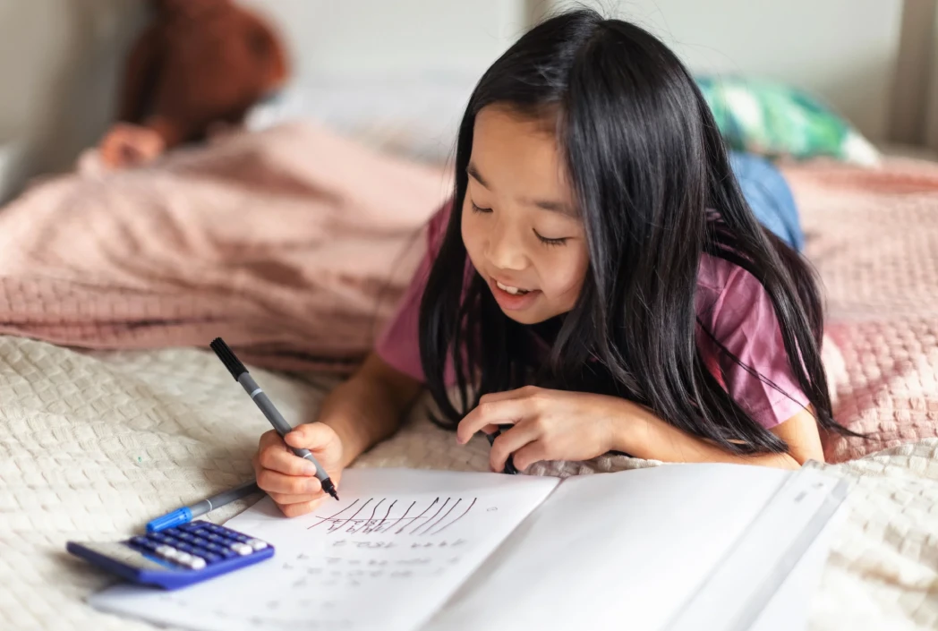 Parent and student reviewing learning plans together on a laptop, supporting age-appropriate study habits and academic success at home.